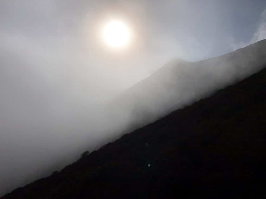 A fog-covered landscape, with the sun beyond.